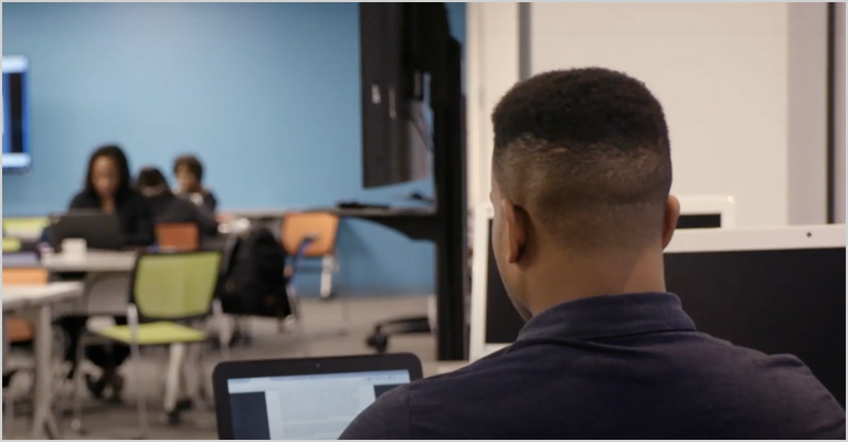 Man on computer in class