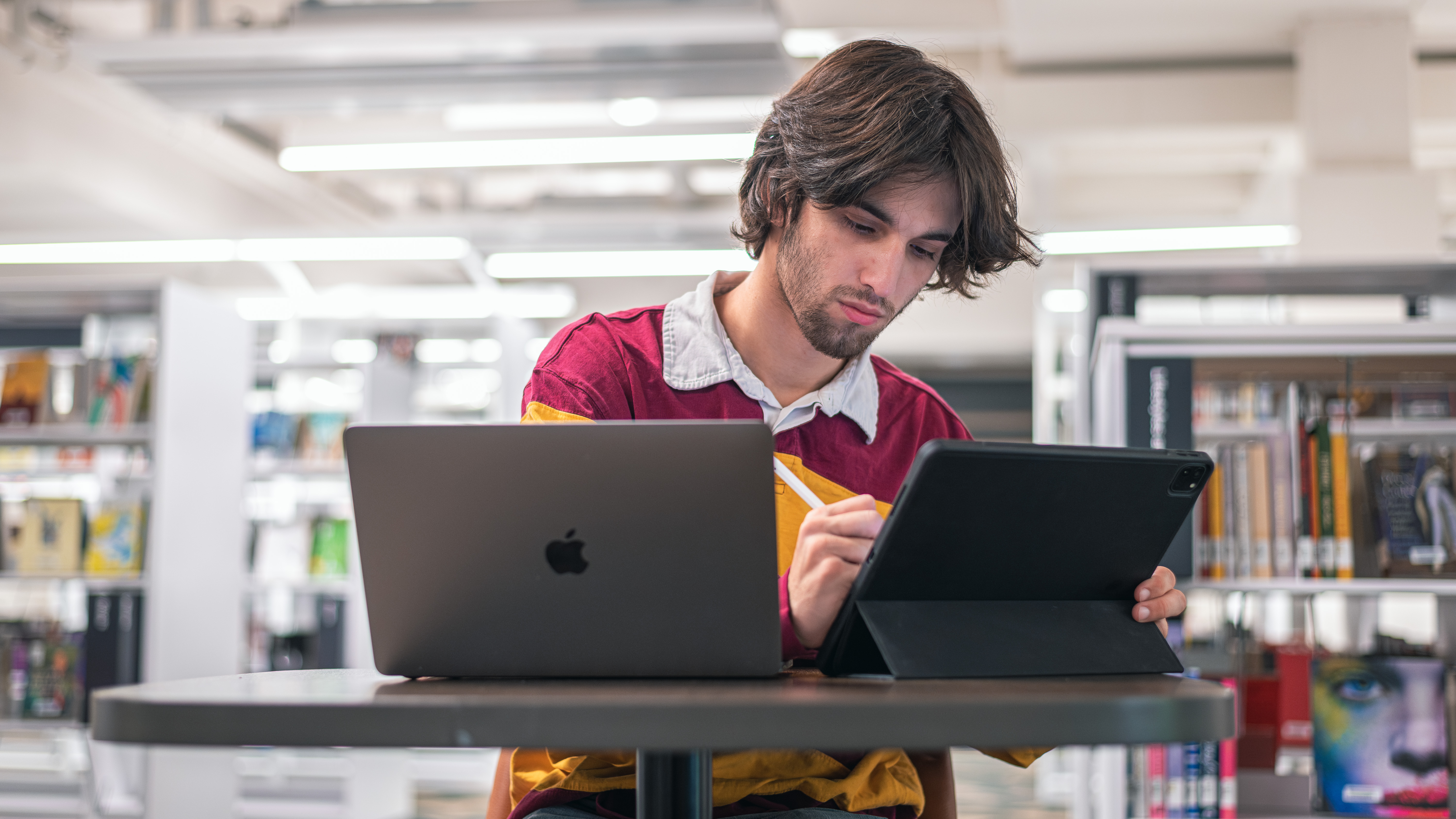 Student on iPad and laptop computer