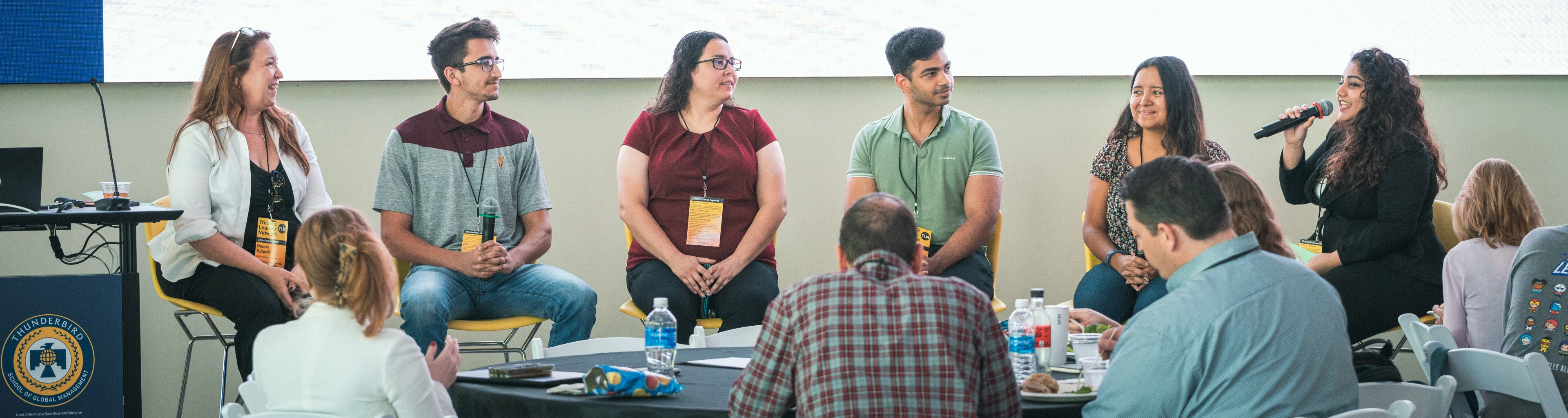 Group of people chatting in a circle at a conference