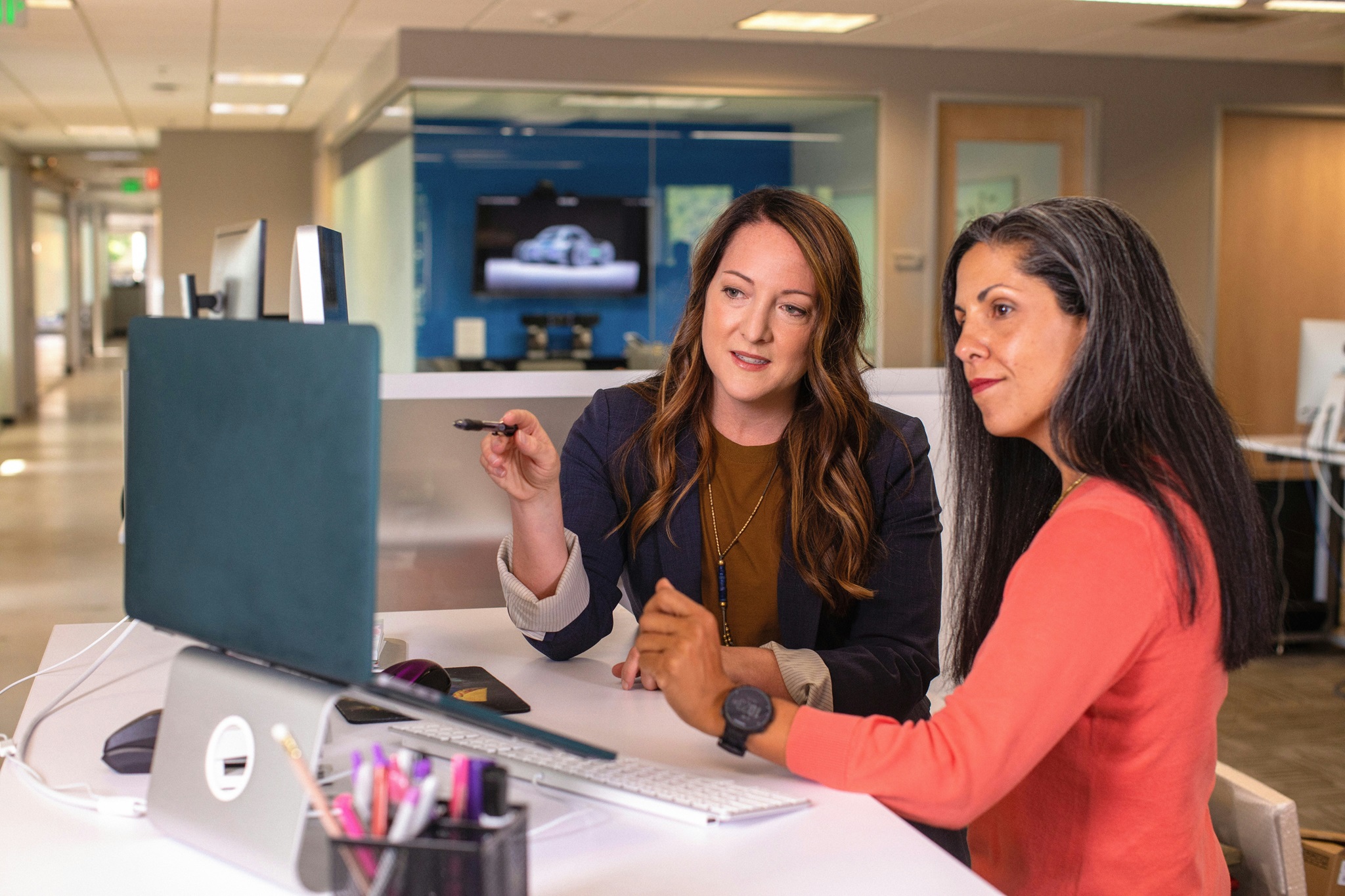 Two female colleagues working at a computer